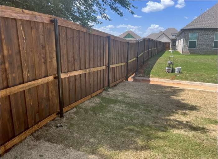 Stained cedar fence with metal posts